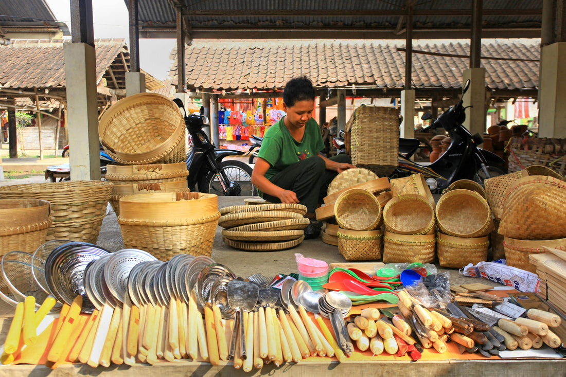 A woman selling wooden products in the market